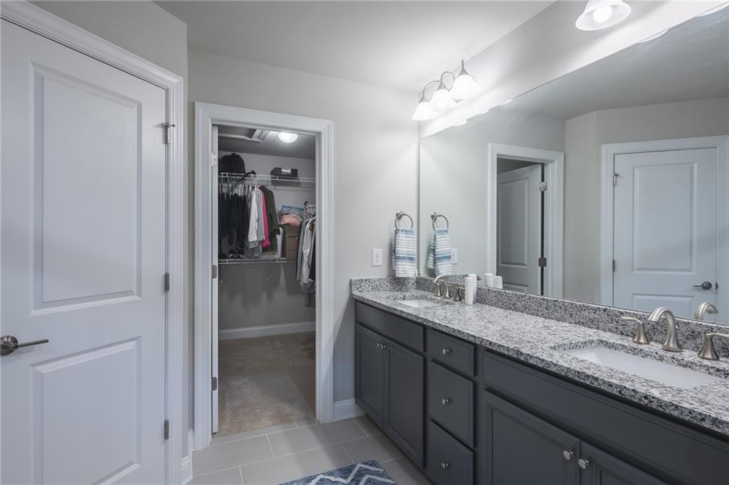 1367 Harris Way Street Brookhaven, GA 30319 - Photo 22 of 49 a bathroom with a granite countertop double vanity sink and a mirror