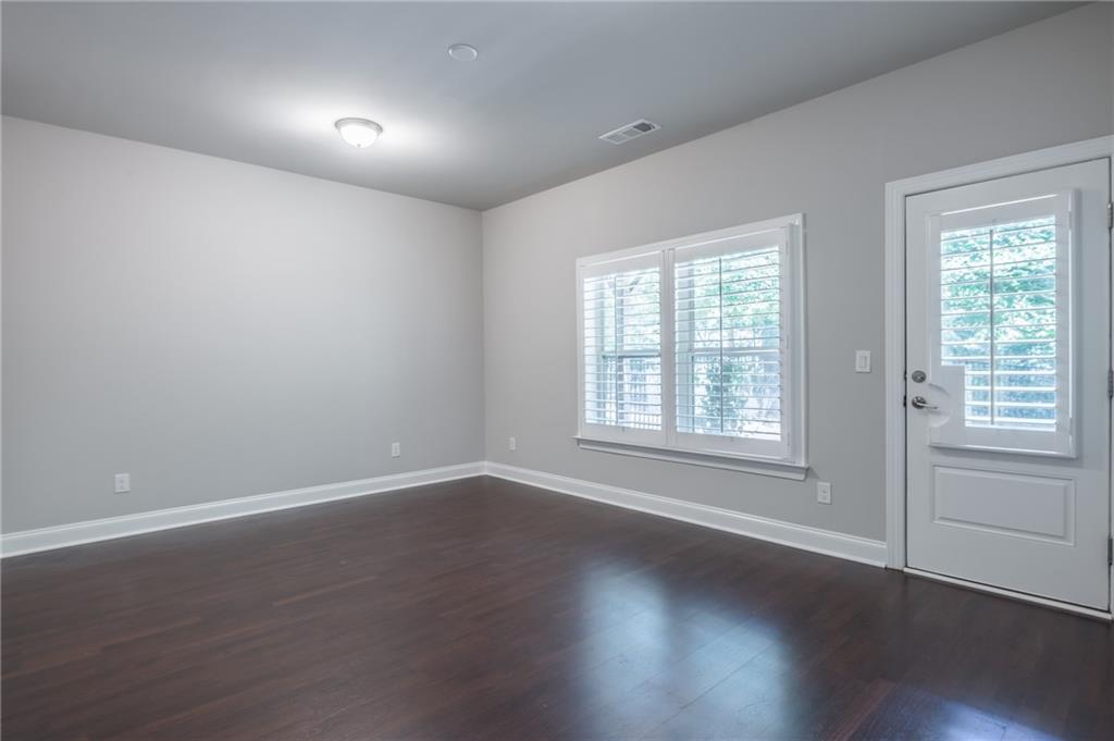 1367 Harris Way Street Brookhaven, GA 30319 - Photo 30 of 49 an empty room with wooden floor and windows