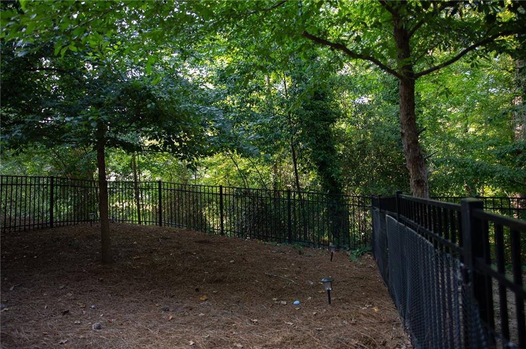 1367 Harris Way Street Brookhaven, GA 30319 - Photo 3 of 49 a view of a backyard with trees and wooden fence