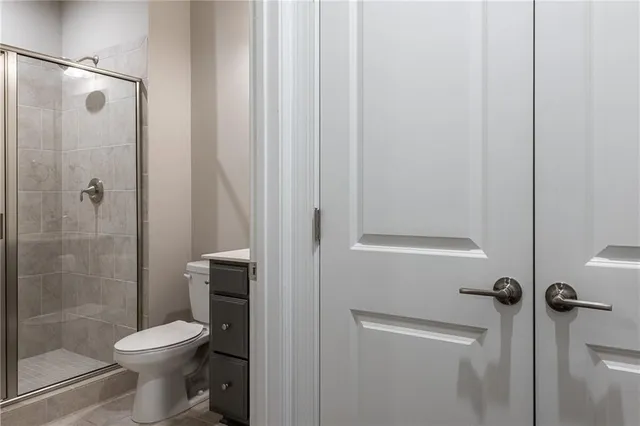 a bathroom with a toilet and a shower