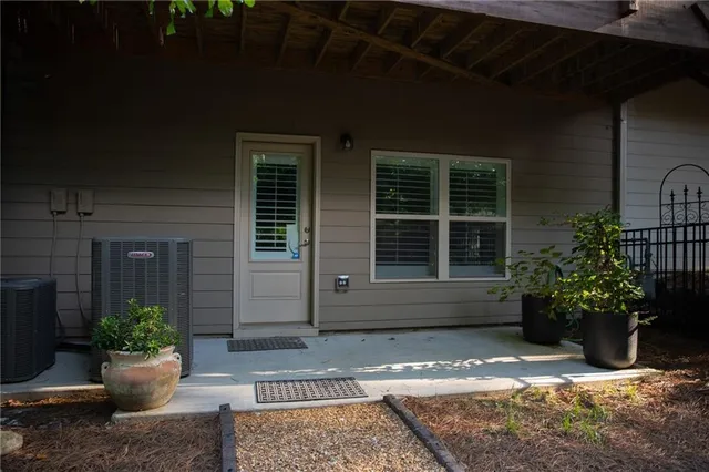 a view of a house with potted plants