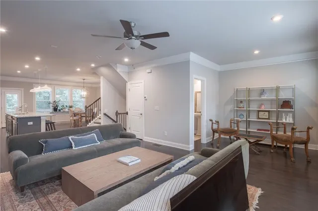 a living room with furniture and a book shelf