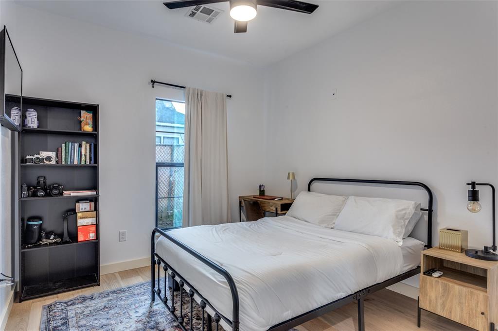 3120 Colcord Avenue Waco, TX 76707 - Photo 22 of 23 a bedroom with a bed and a chandelier