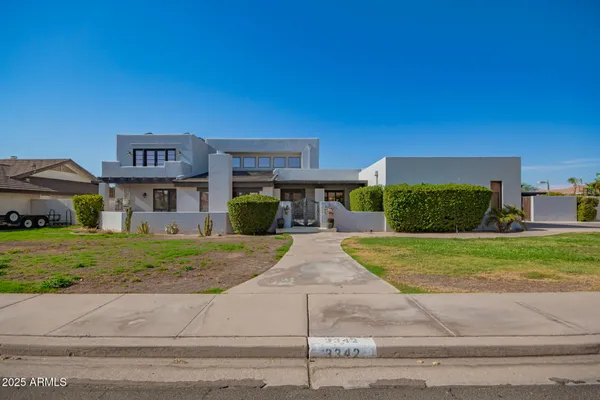 a front view of a house with a yard and a garage