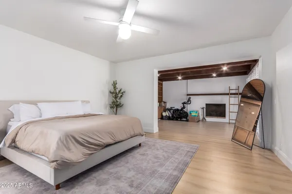 a spacious bedroom with a bed and a chandelier