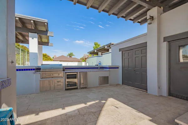 a view of pool with lawn chairs and large trees