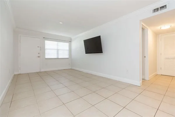 a view of a livingroom with an empty space and a window
