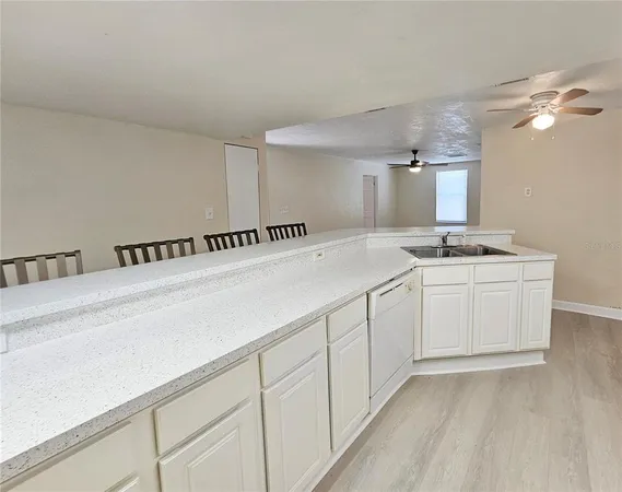 a kitchen with granite countertop a white cabinets and sink