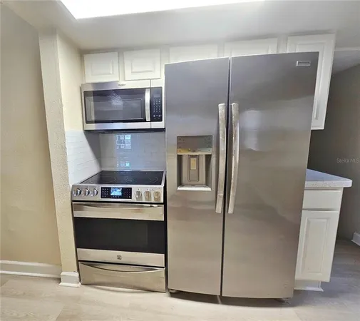 a kitchen with a stove and a refrigerator