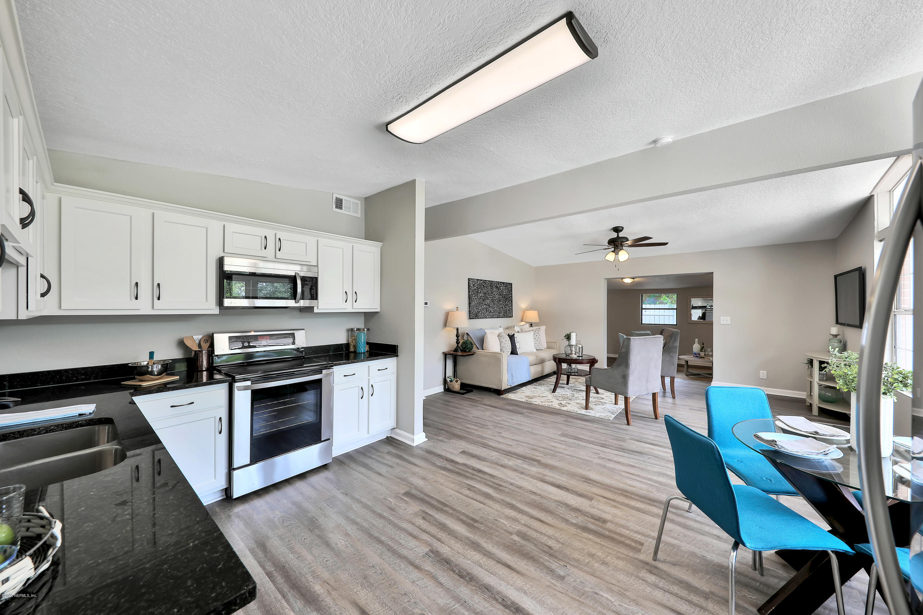 7359 Sandhurst Road South Jacksonville, FL 32277 - Photo 11 of 34 a kitchen with stainless steel appliances stove top oven and cabinets
