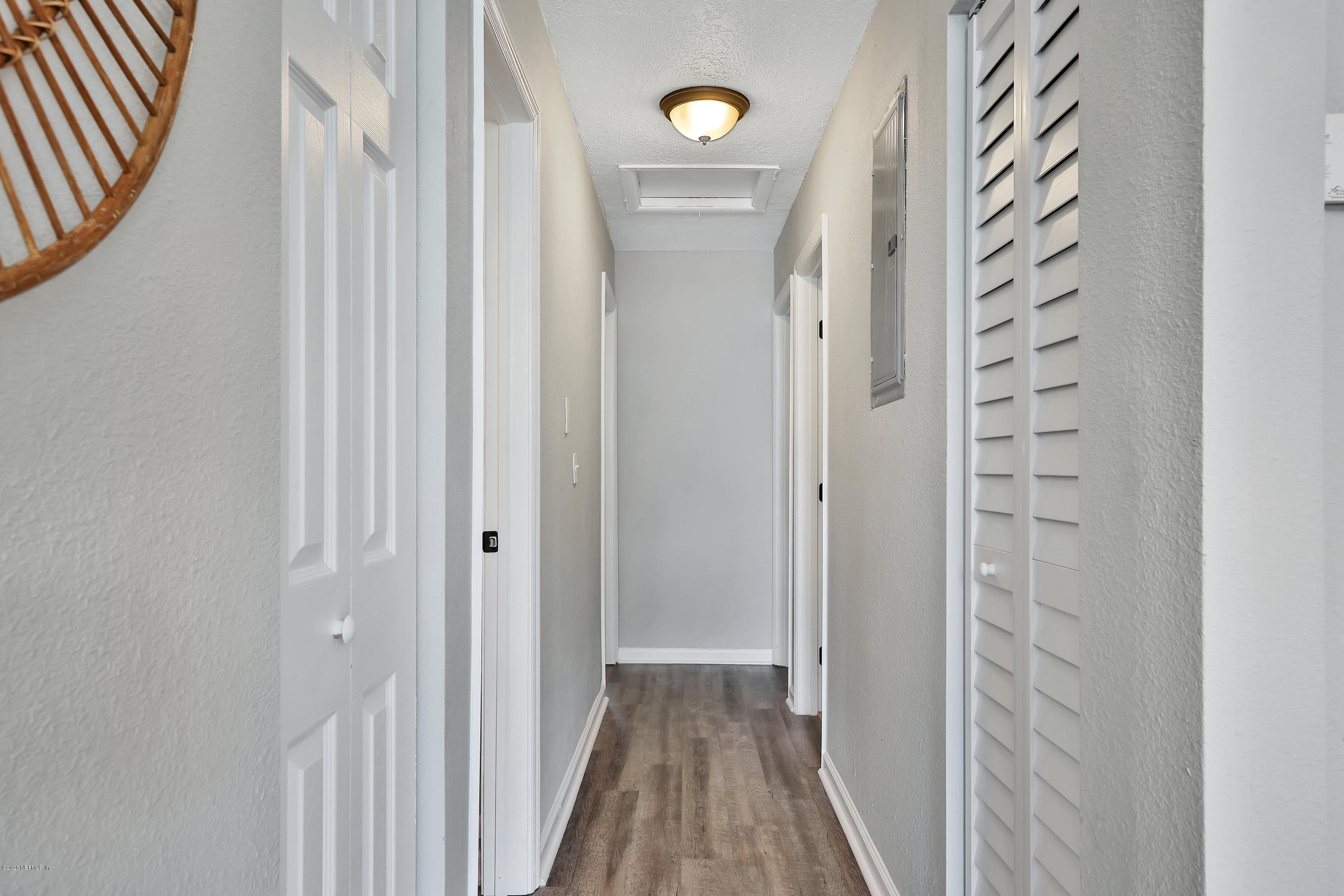 7359 Sandhurst Road South Jacksonville, FL 32277 - Photo 17 of 34 a view of a hallway with wooden floor and closet