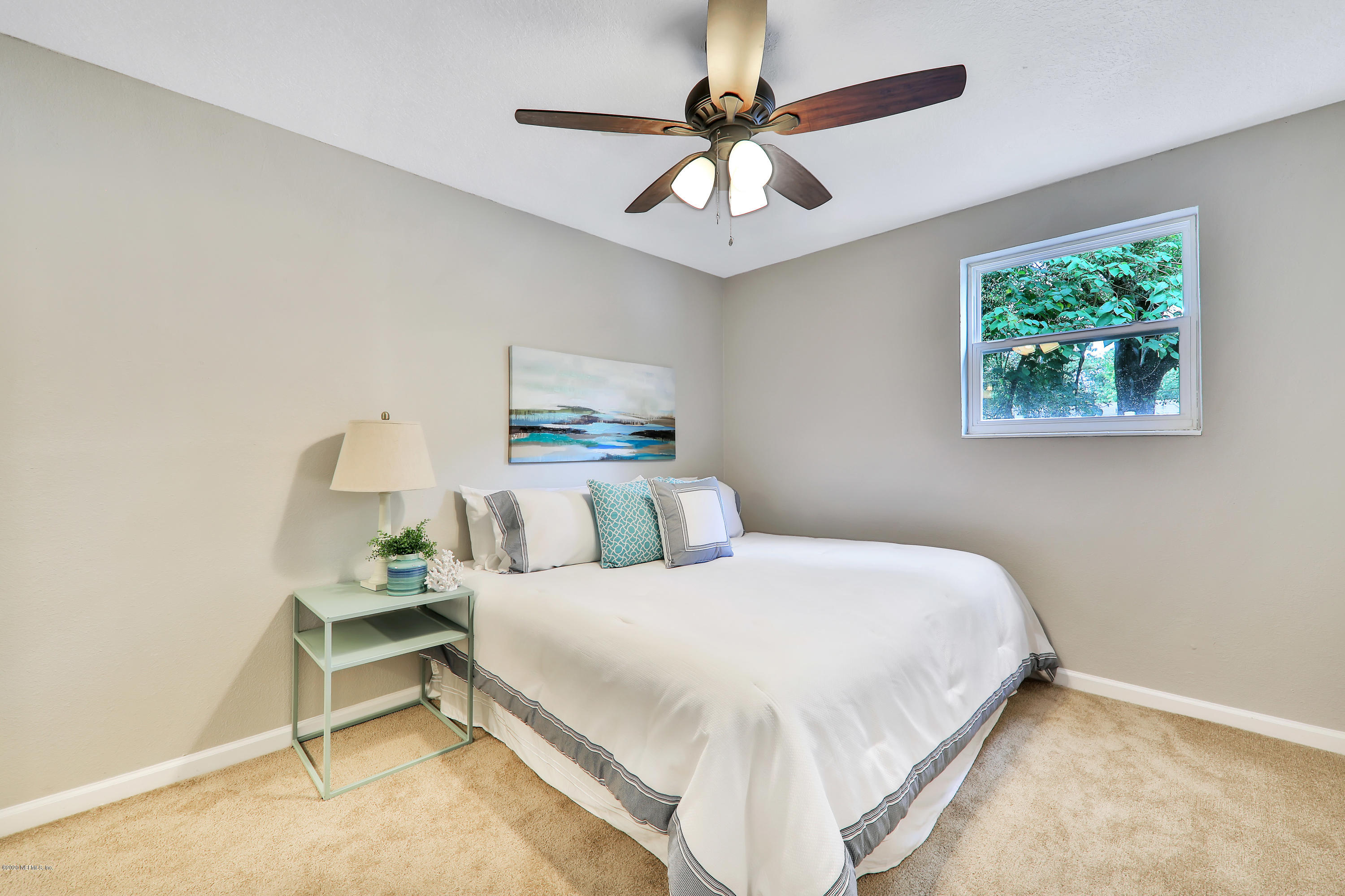 7359 Sandhurst Road South Jacksonville, FL 32277 - Photo 18 of 34 a bedroom with a bed and a chandelier