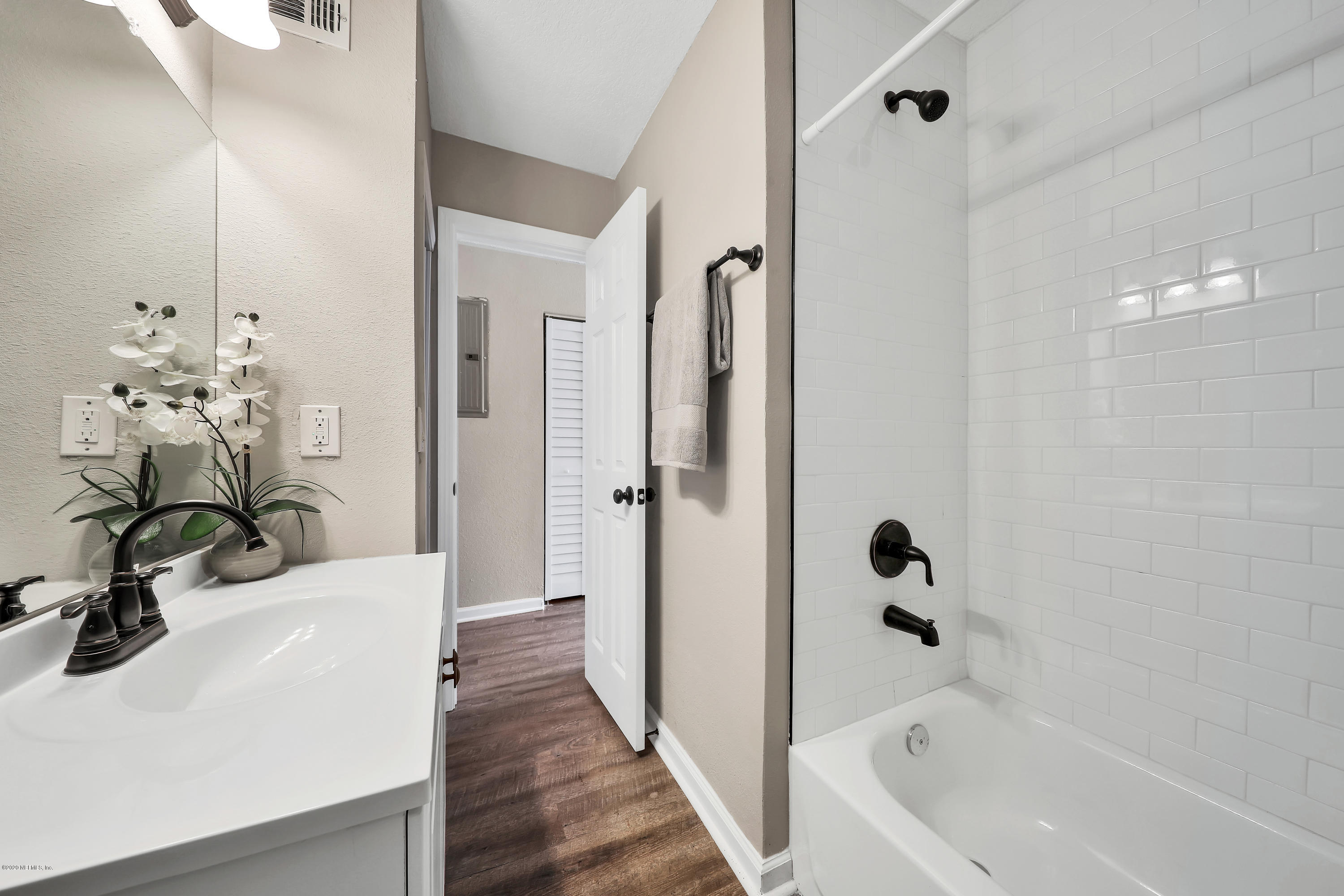 7359 Sandhurst Road South Jacksonville, FL 32277 - Photo 23 of 34 a bathroom with a tub sink and glass door shower