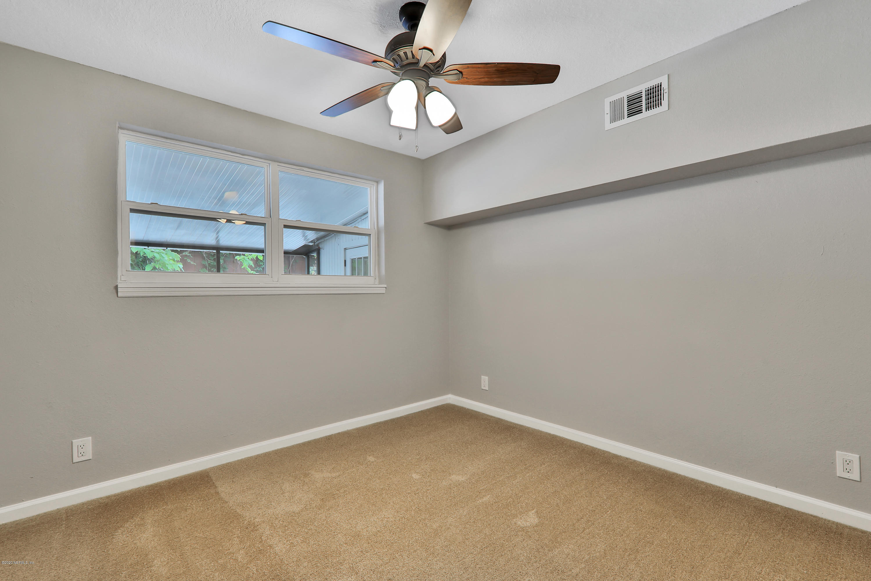 7359 Sandhurst Road South Jacksonville, FL 32277 - Photo 25 of 34 a view of an empty room with a window
