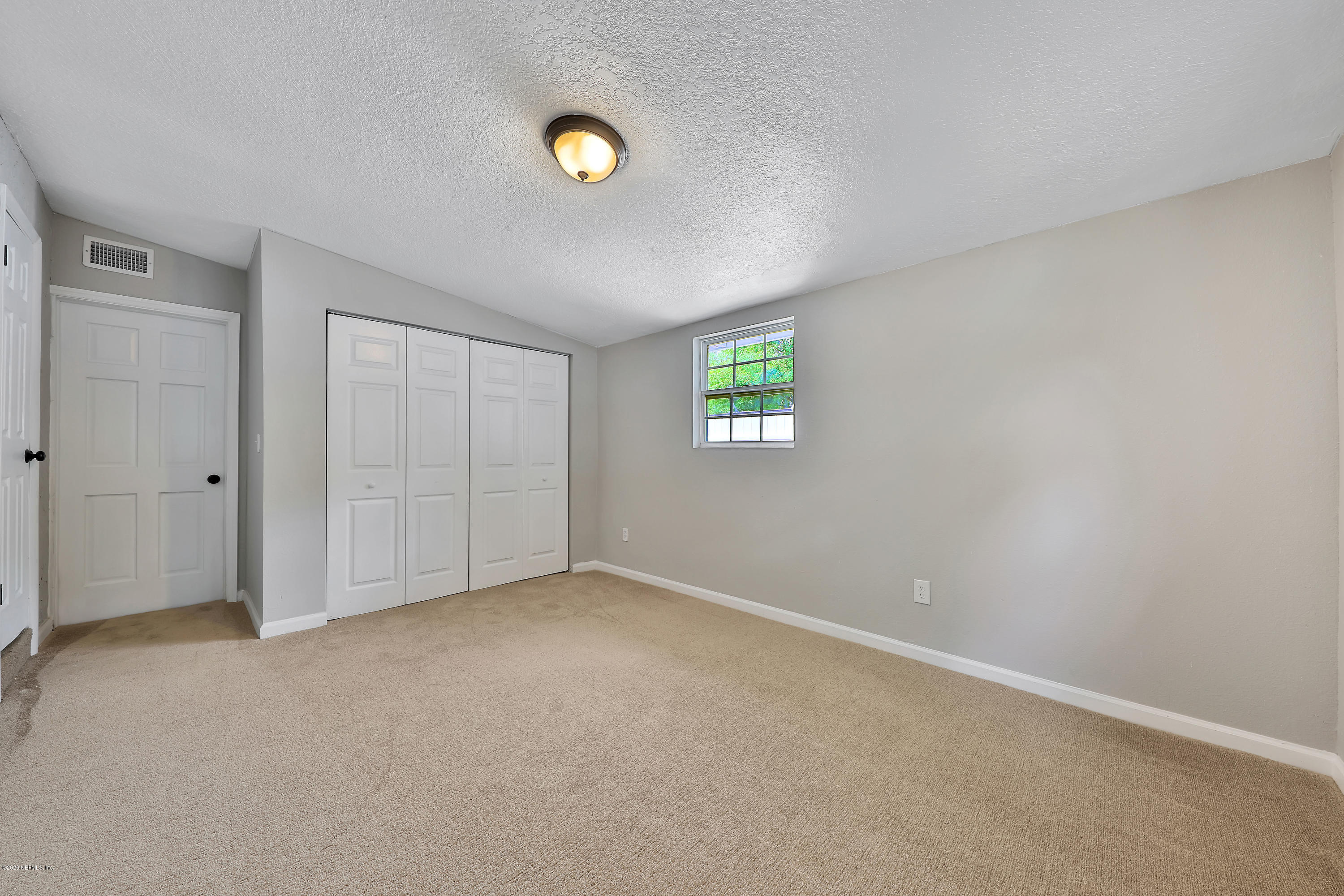 7359 Sandhurst Road South Jacksonville, FL 32277 - Photo 27 of 34 a view of an empty room with a window