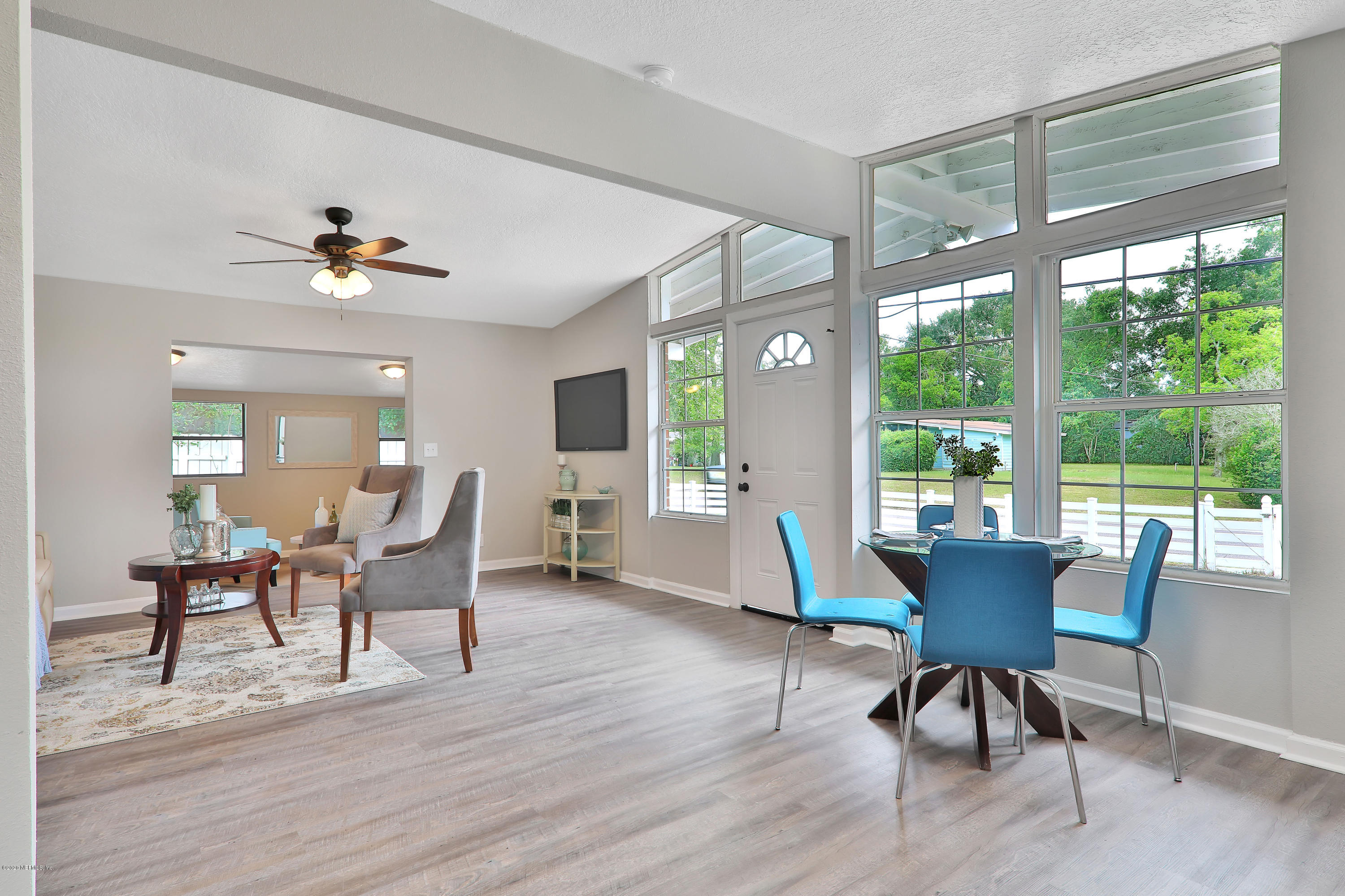 7359 Sandhurst Road South Jacksonville, FL 32277 - Photo 4 of 34 a dining room with furniture a chandelier and wooden floor