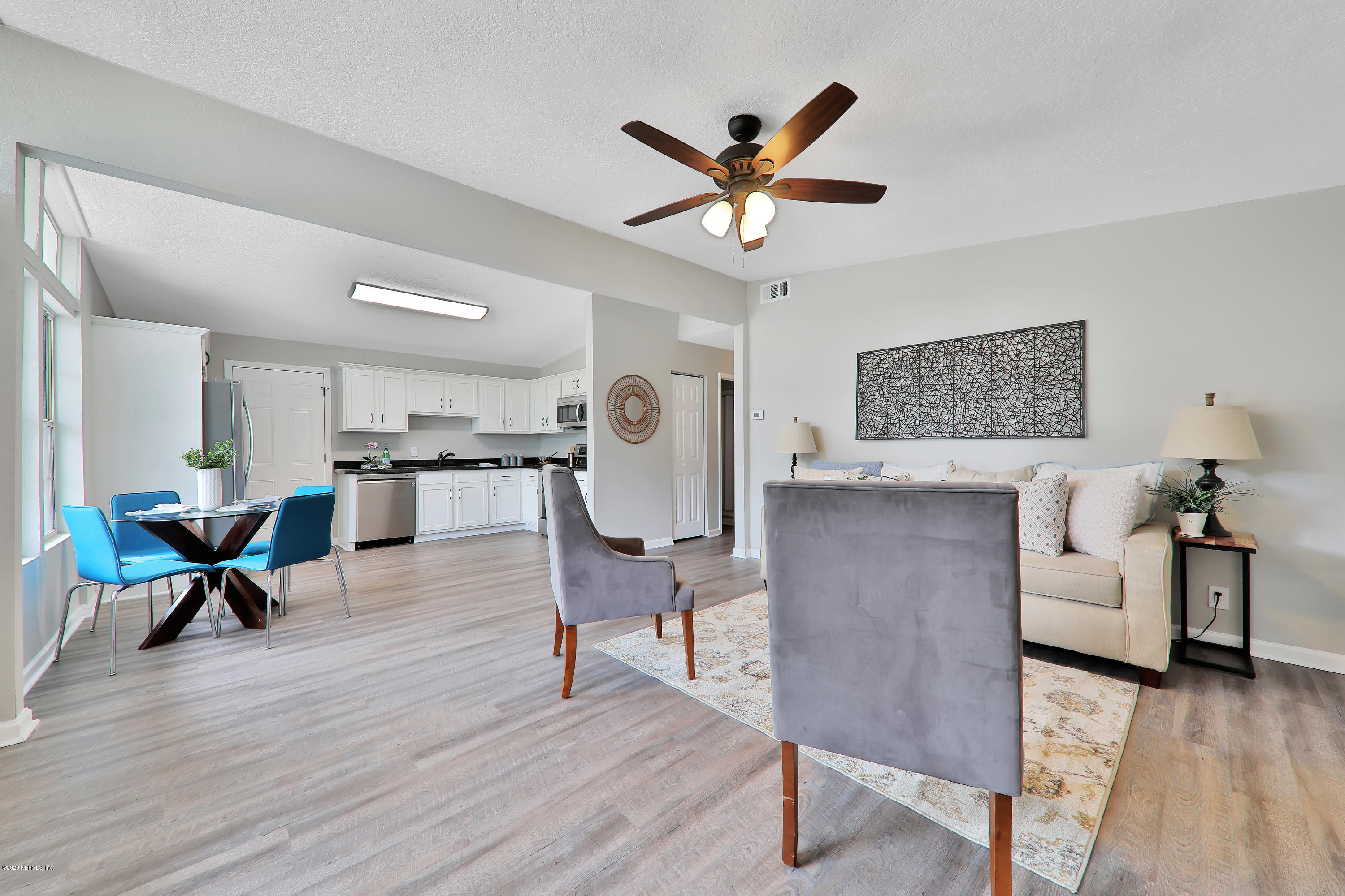 7359 Sandhurst Road South Jacksonville, FL 32277 - Photo 5 of 34 a living room with furniture and kitchen view