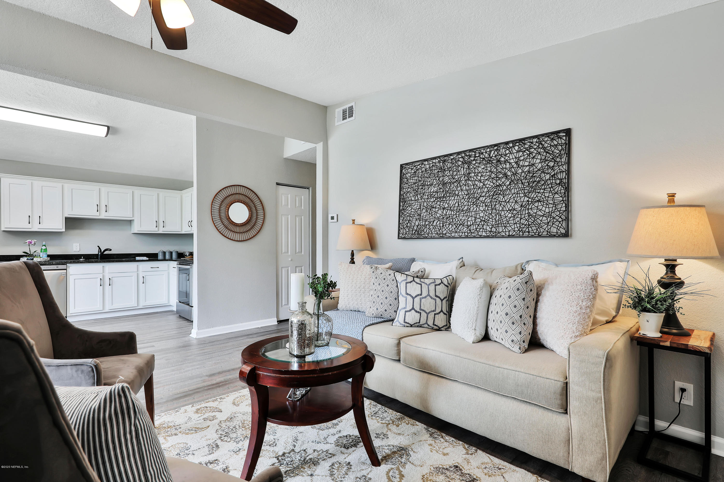 7359 Sandhurst Road South Jacksonville, FL 32277 - Photo 6 of 34 a living room with furniture and a clock