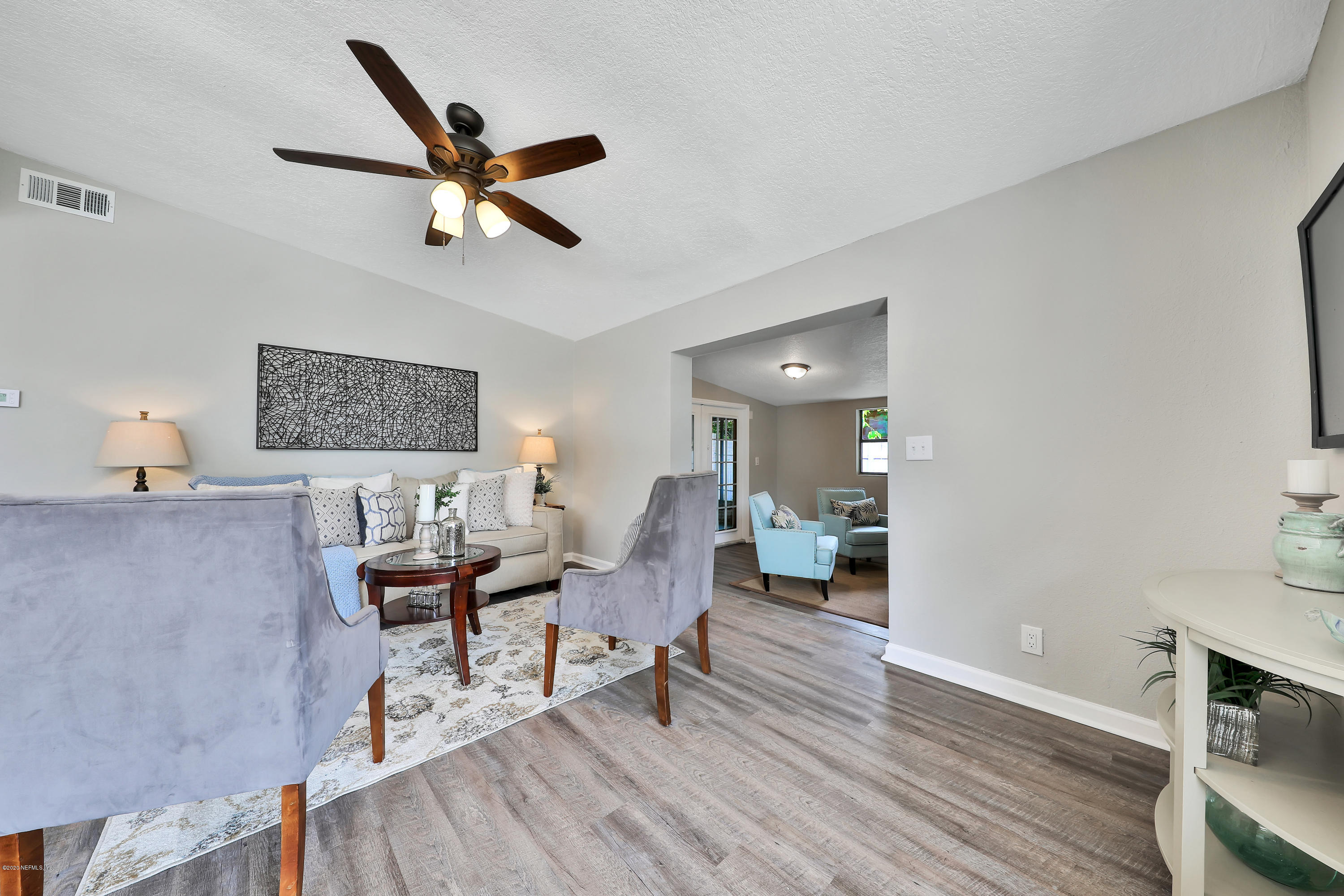 7359 Sandhurst Road South Jacksonville, FL 32277 - Photo 7 of 34 a living room with furniture and a wooden floor