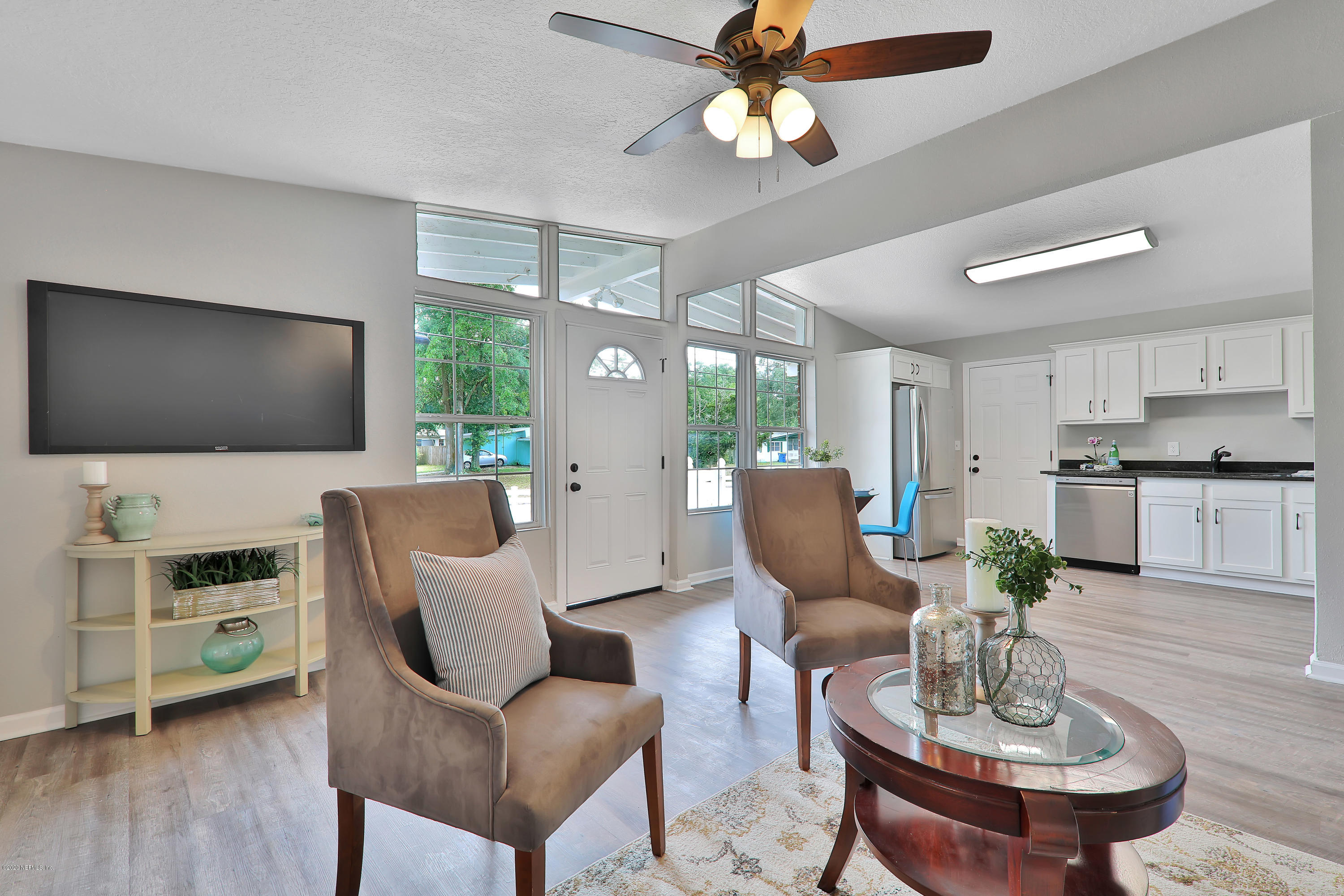 7359 Sandhurst Road South Jacksonville, FL 32277 - Photo 8 of 34 a living room with furniture and a flat screen tv