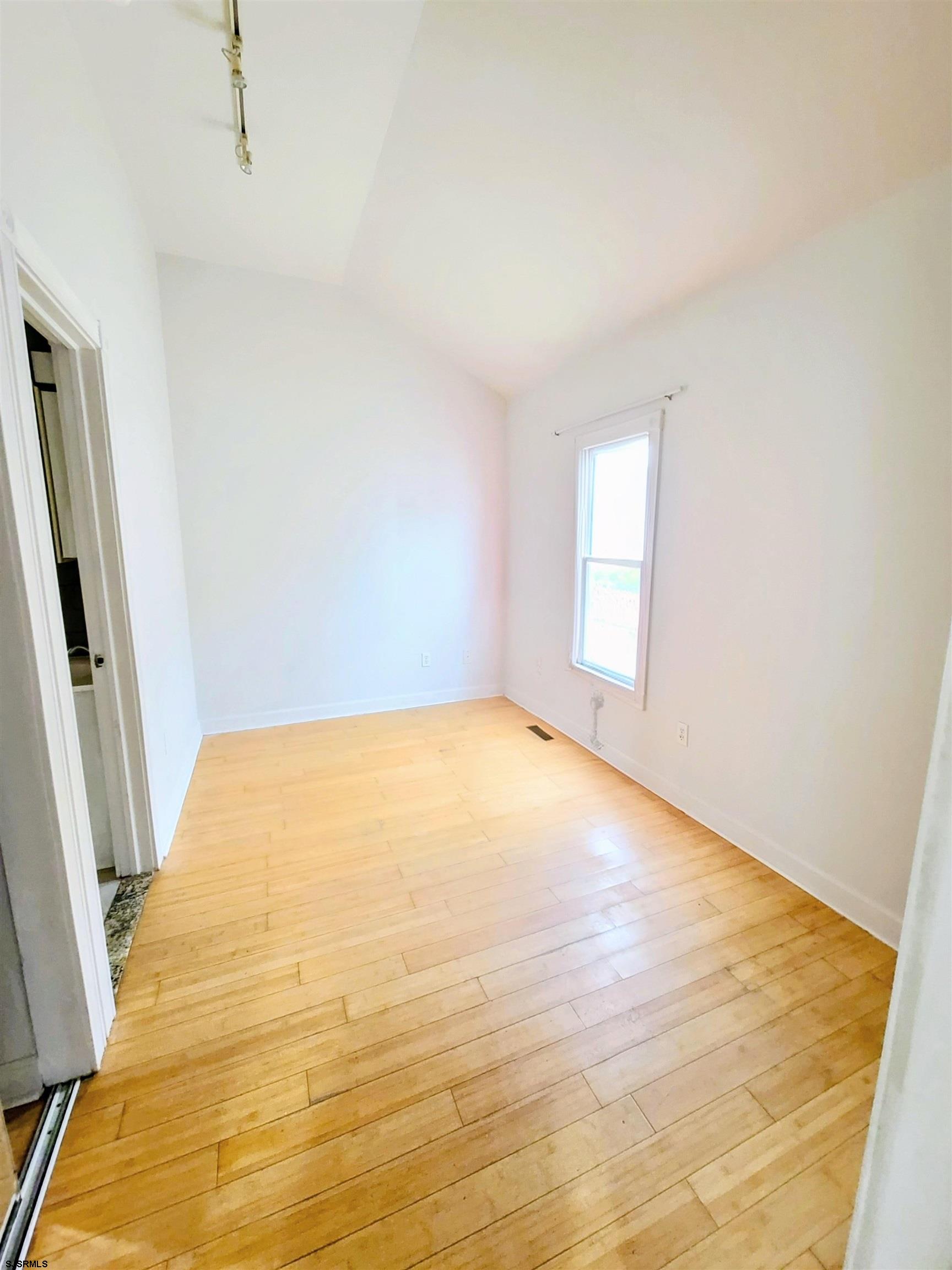 711 Wisteria Road Chelsea Heights, NJ 08401 - Photo 8 of 26 a view of empty room with wooden floor and fan