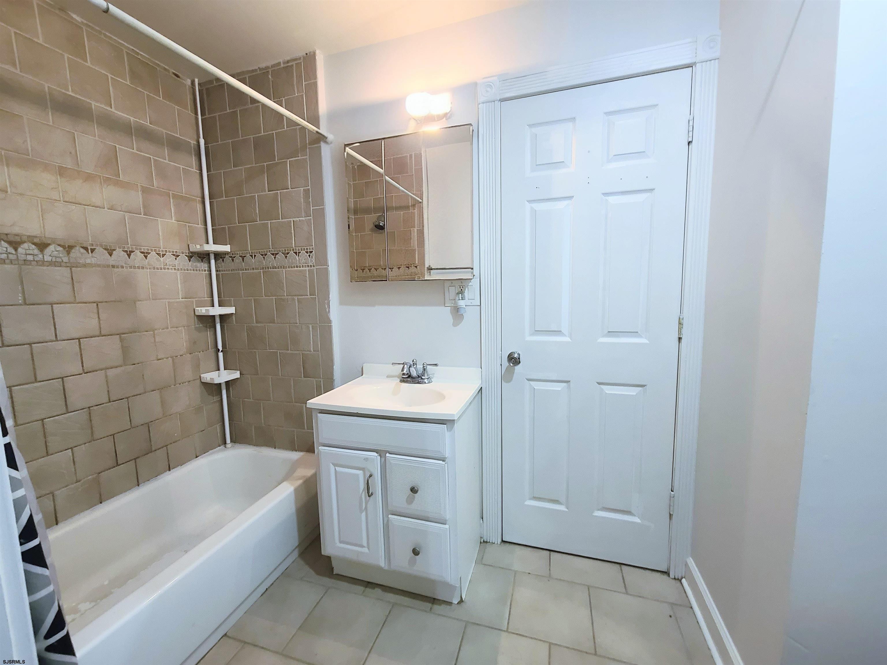 711 Wisteria Road Chelsea Heights, NJ 08401 - Photo 9 of 26 a bathroom with a sink a toilet and shower