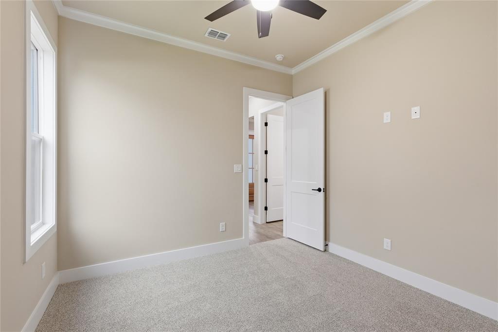 702 Anne Road Van Alstyne, TX 75495 - Photo 13 of 27 Neutral-toned room with light gray carpeting and white trim