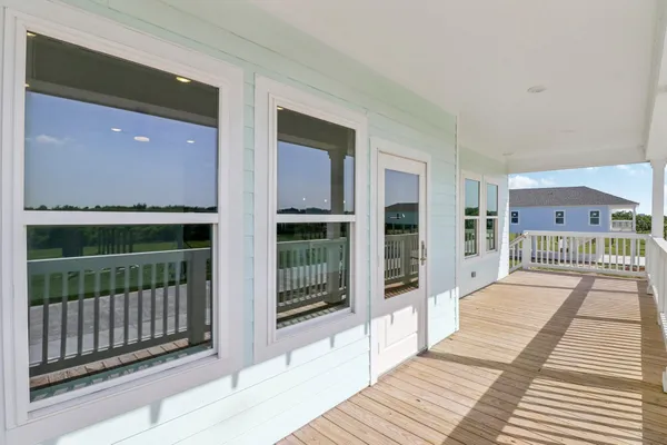 a view of a balcony with wooden floor