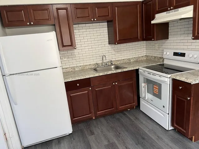 a utility room with sink dryer and washer