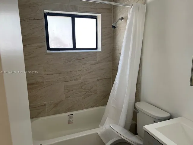 a bathroom with a bathtub and window