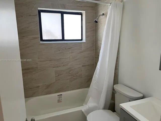 a bathroom with a toilet and a bathtub