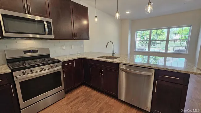 a kitchen with a sink stove and microwave