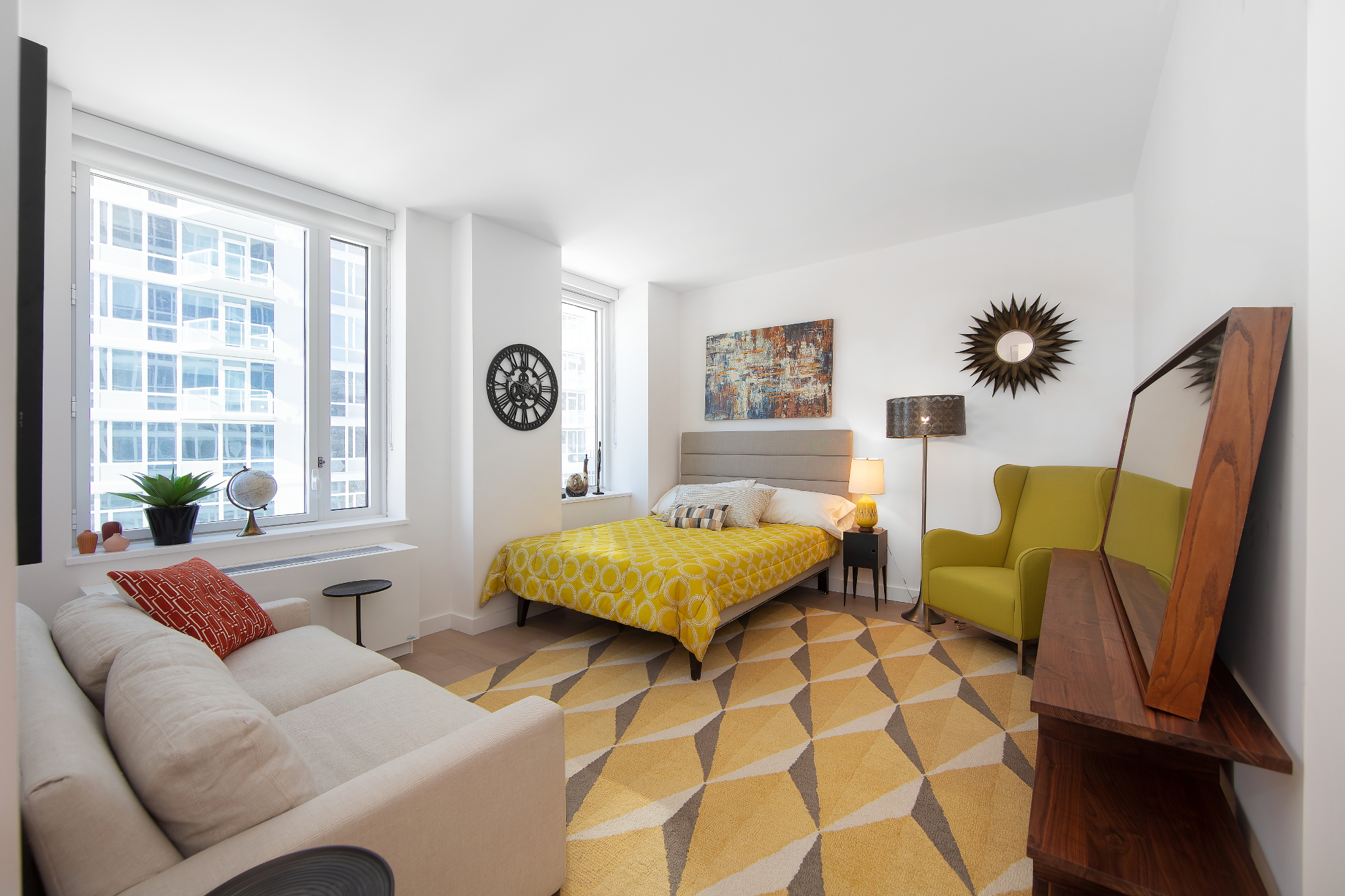 a spacious bedroom with a bed and a couch