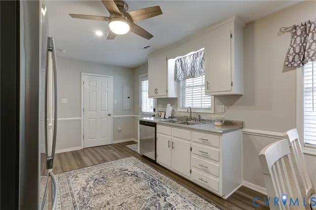 a kitchen with a sink cabinets and window