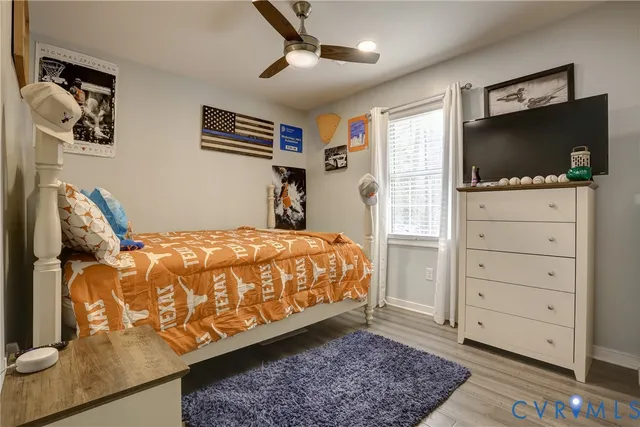 a bedroom with a bed and flat screen tv