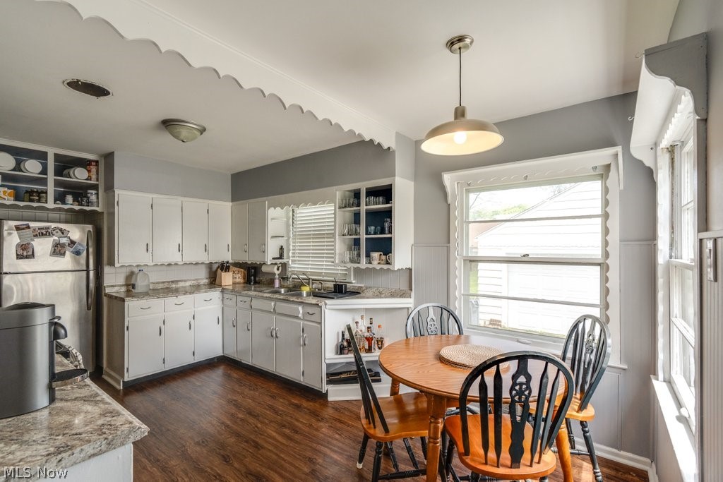 3569 Elm Road Stow, OH 44224 - Photo 3 of 17 Kitchen space featuring white cabinetry, wood-finish flooring, and light gray wall paneling
