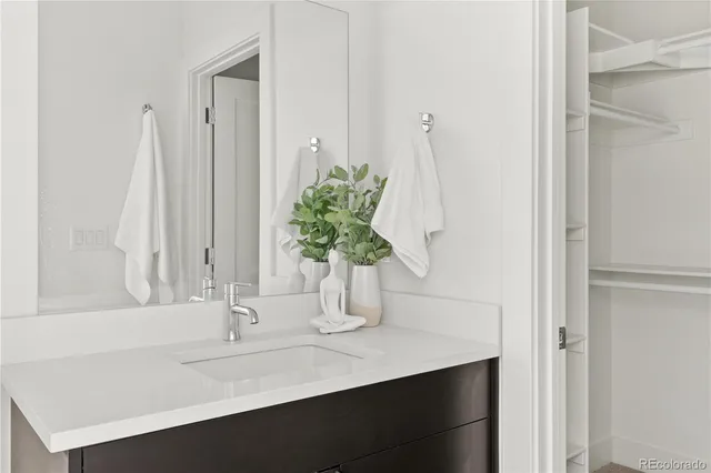a bathroom with a sink a vanity and a mirror