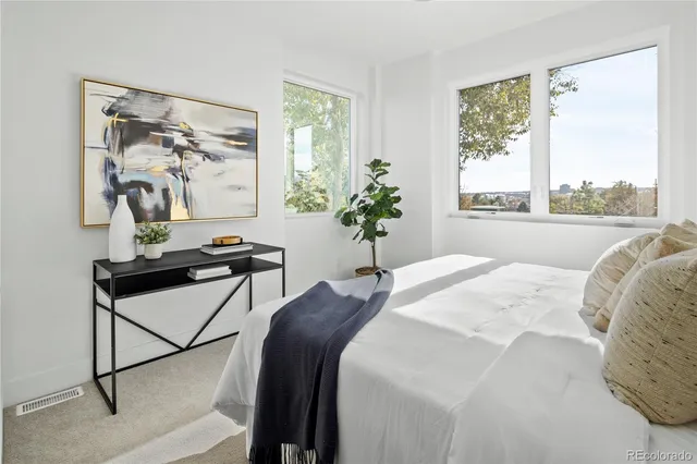 a bed sitting in a bedroom next to a window