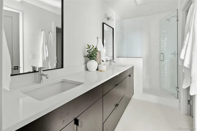 a bathroom with a double vanity sink and mirror