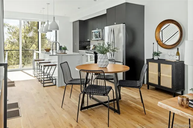 a dining room with furniture a chandelier and wooden floor