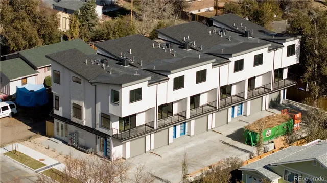 a view of a white building among the street