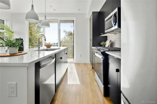 a kitchen with stainless steel appliances granite countertop a sink and cabinets