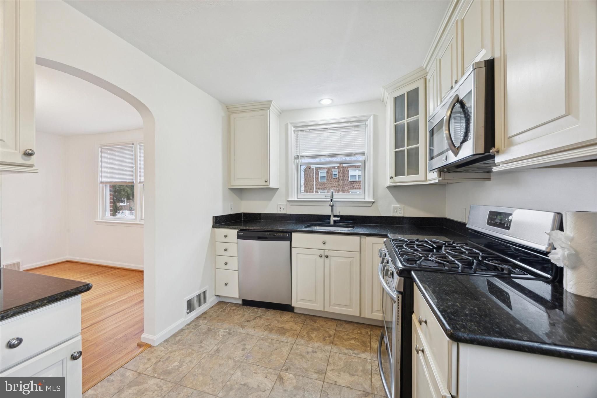 519 Acorn Street Philadelphia, PA 19128 - Photo 13 of 29 a kitchen with stainless steel appliances granite countertop a sink stove and cabinets