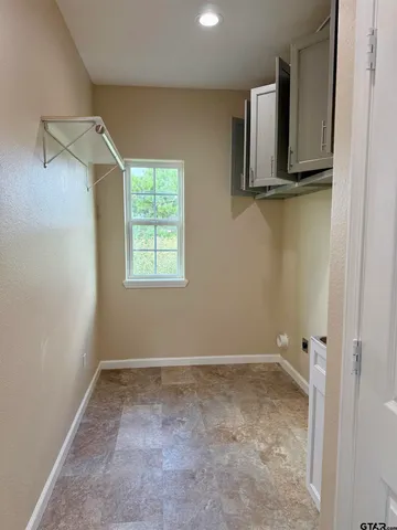 a kitchen with cabinets and a stove