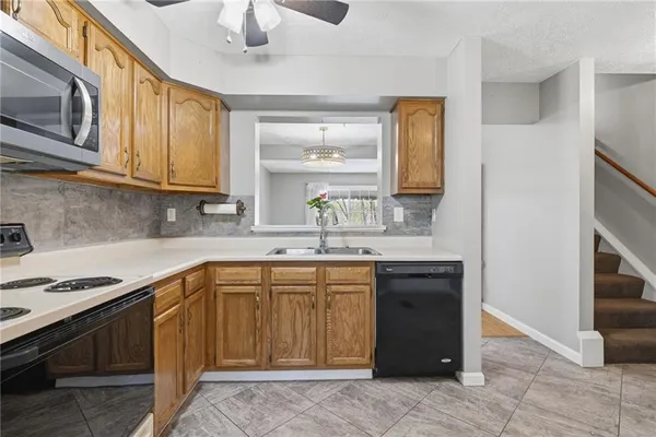 a kitchen with stainless steel appliances granite countertop a sink and cabinets