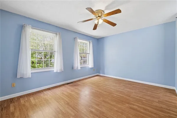 a view of an empty room with wooden floor