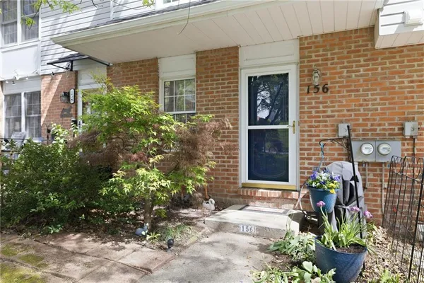 a front view of a house with a potted plant