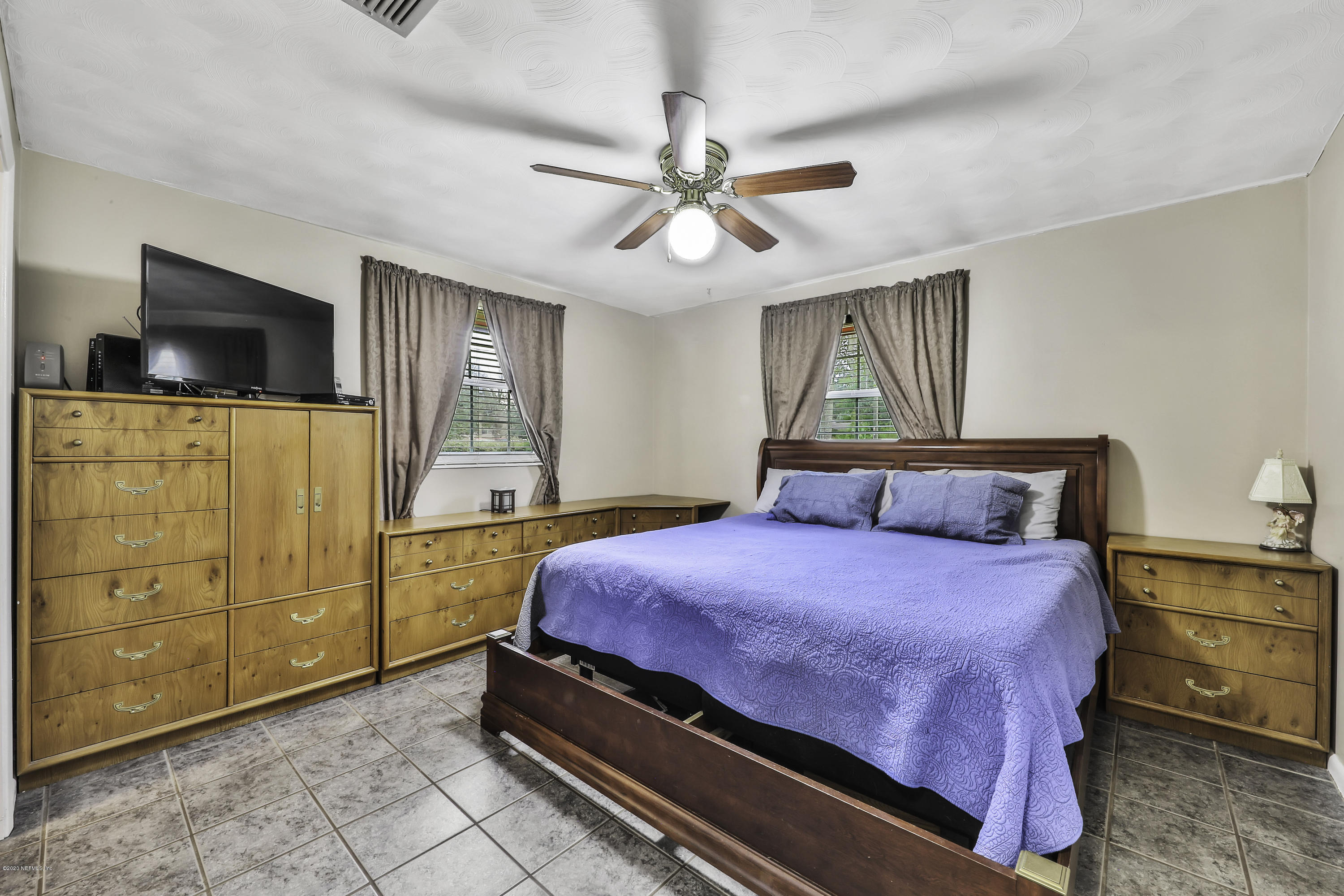 6161 Carlton Road Jacksonville, FL 32244 - Photo 12 of 26 a bedroom with a bed and a walk in closet