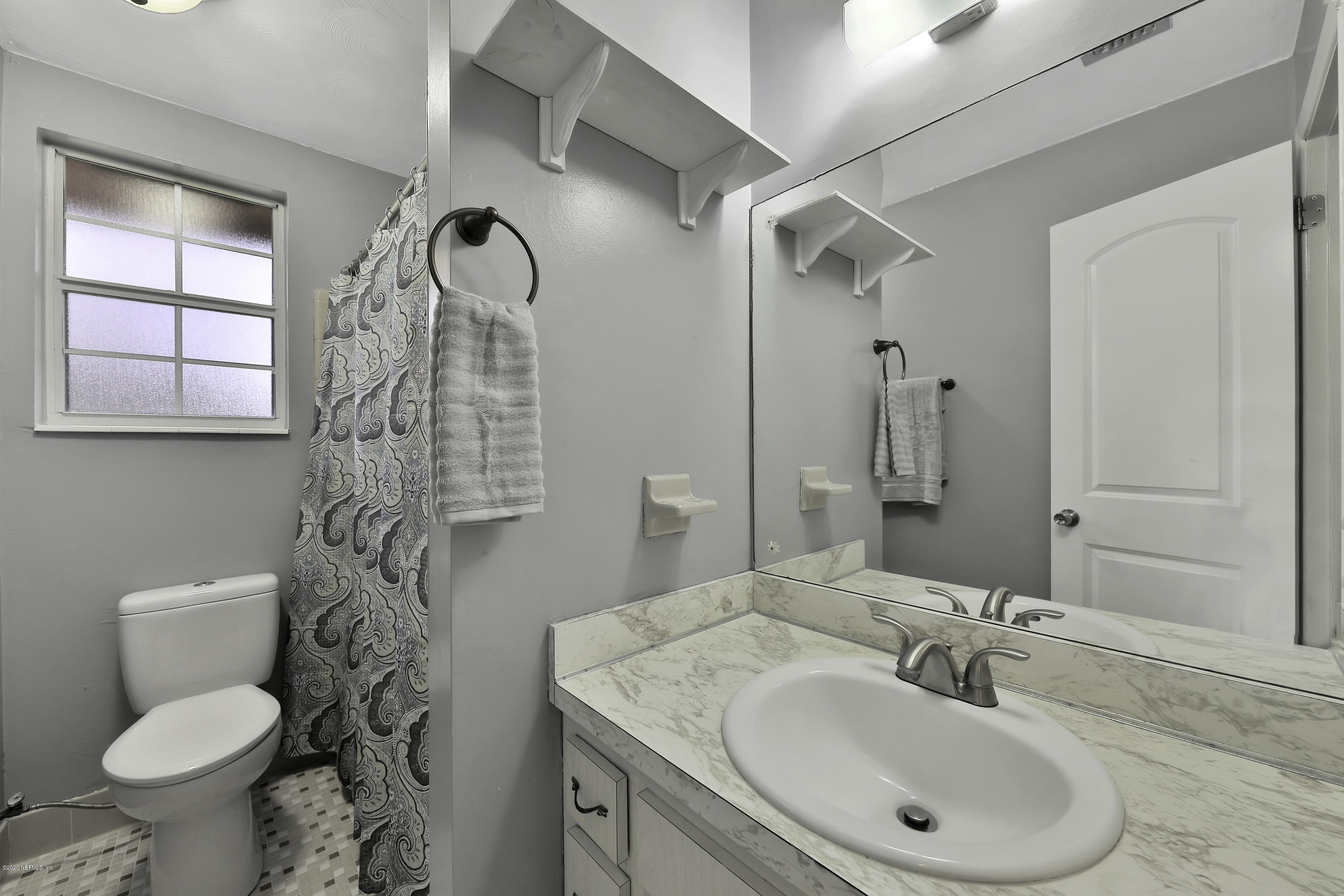 6161 Carlton Road Jacksonville, FL 32244 - Photo 16 of 26 a bathroom with a sink toilet and shower