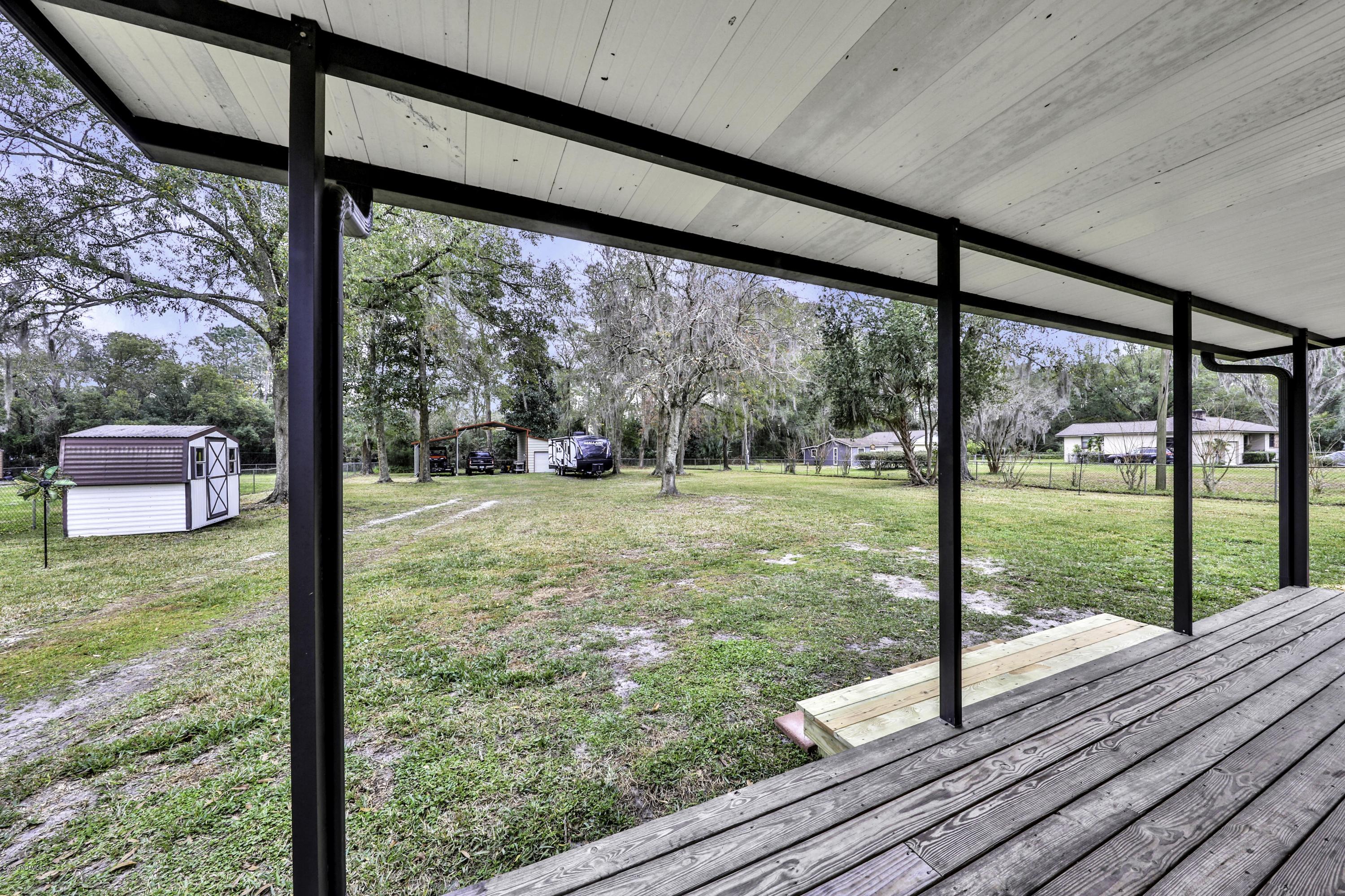 6161 Carlton Road Jacksonville, FL 32244 - Photo 19 of 26 a view of a room with wooden floor and fence